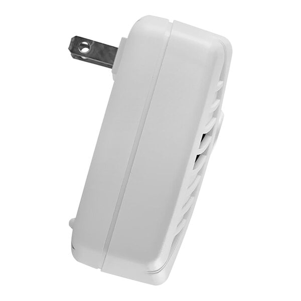 A First Alert plug-in carbon monoxide alarm with a metal holder.