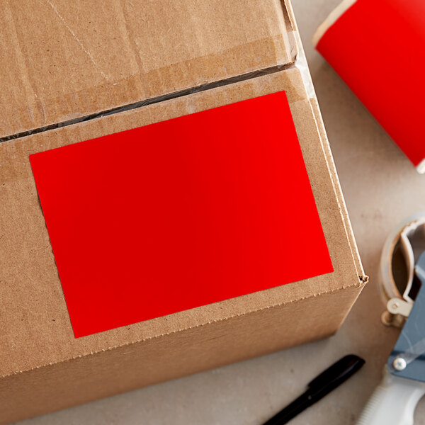 A cardboard box with a red rectangular Lavex inventory label on it.