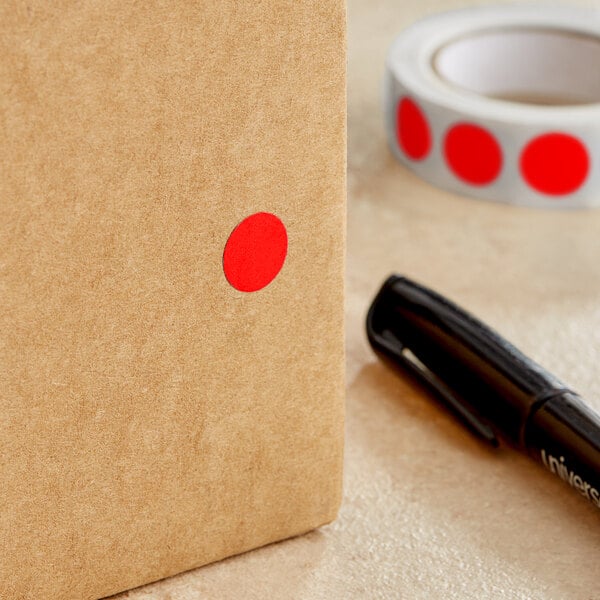 A brown box with a red circle label next to a black marker.
