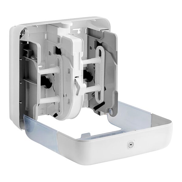 A white wall mounted Tork Coreless toilet paper dispenser box with plastic parts.
