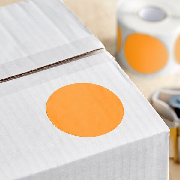 A white box with a roll of Lavex fluorescent orange inventory labels with orange semi-gloss paper.