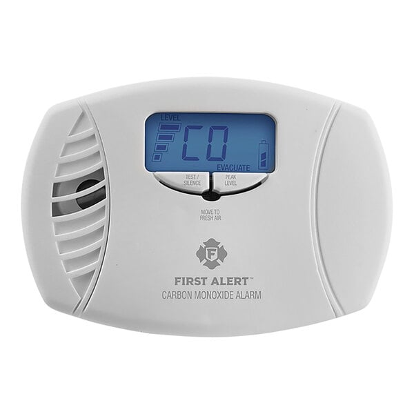 A white First Alert carbon monoxide alarm with a blue digital display.