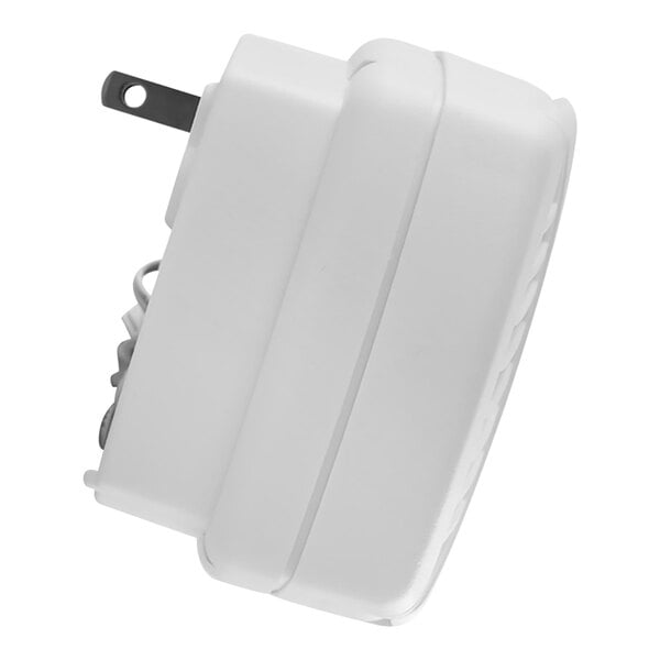 A white plastic device with a black cord attached to it.