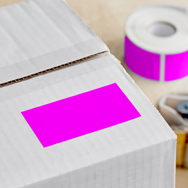 A box with a pink Lavex rectangular inventory label on it.