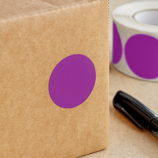 A purple Lavex round sticker on a brown box.