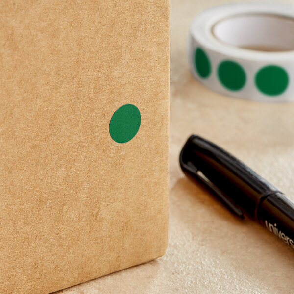 A black pen writing on a brown Lavex box with green dots.