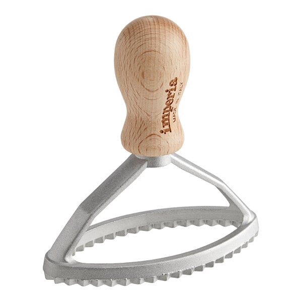 An Imperia metal oval ravioli cutter with a wooden handle.