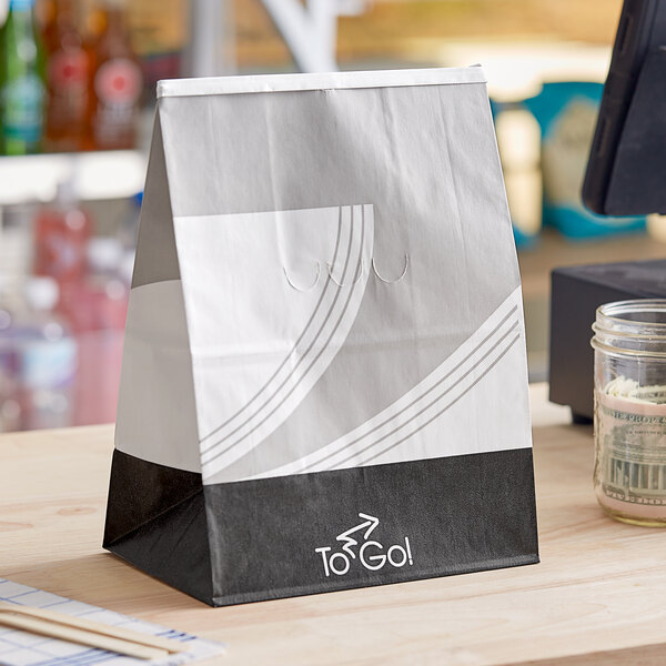 A white Bagcraft meal bag with a design on the table.