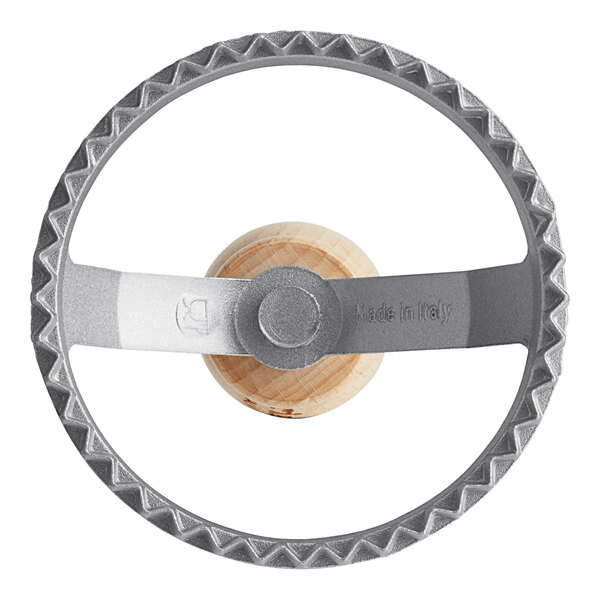 A close-up of the Imperia Circle Ravioli Cutter Stamp wheel with a wooden handle.
