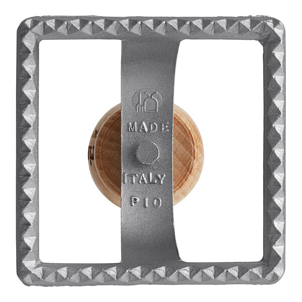 A grey metal Imperia square ravioli cutter stamp with a circle and text.
