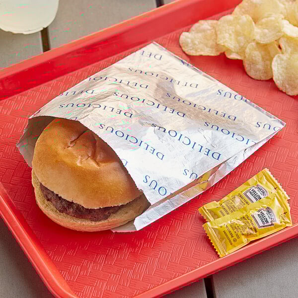A hamburger in a Bagcraft printed foil wrapper.
