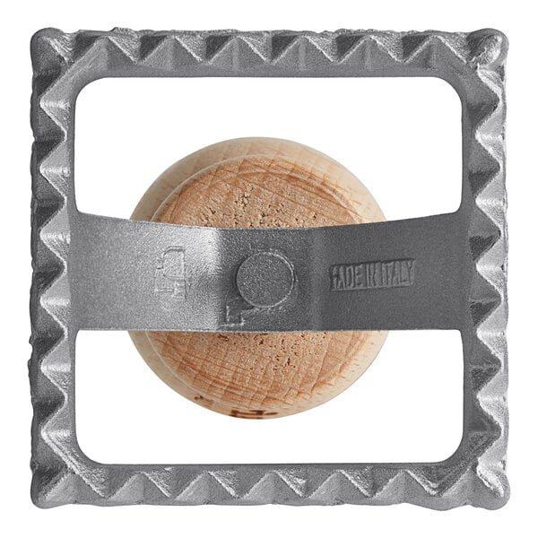 An Imperia square metal ravioli cutter with a wooden handle.