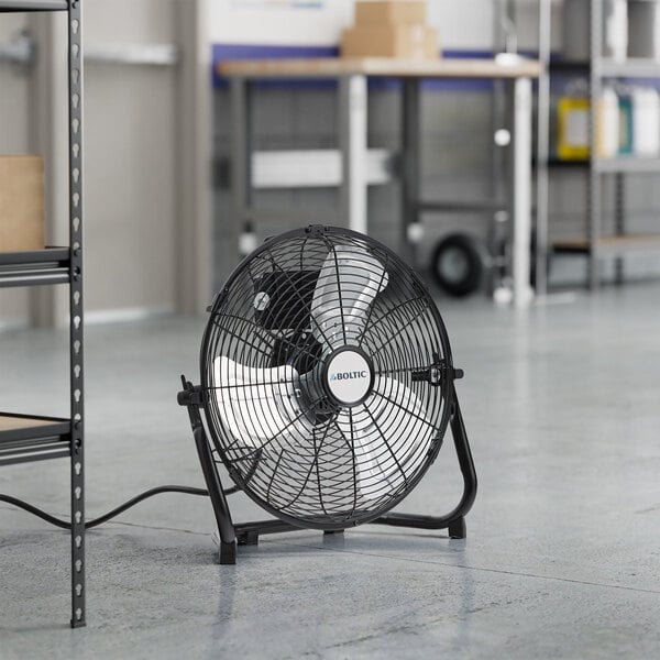 A Boltic black portable high-velocity floor fan with a metal frame.