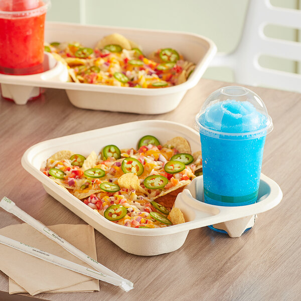 A World Centric compostable serving tray with nachos and a drink on a table.