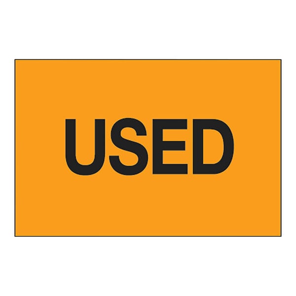 A yellow rectangular label with black text reading "USED" and an orange border.