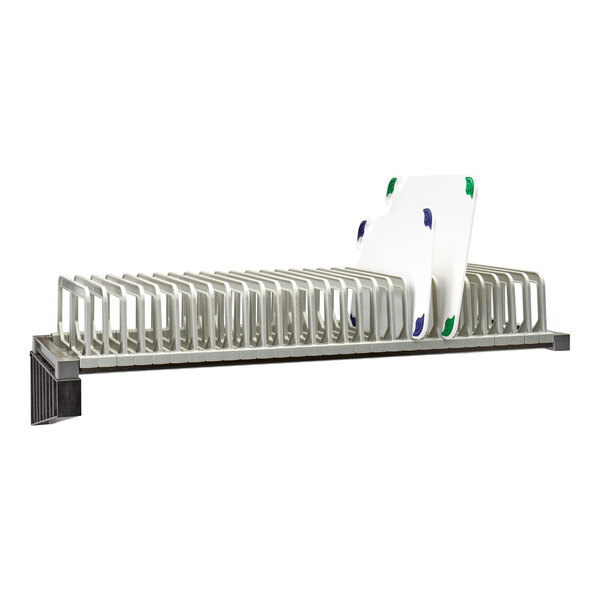 A Cambro Elevation Series drying rack shelf with plastic trays on it.