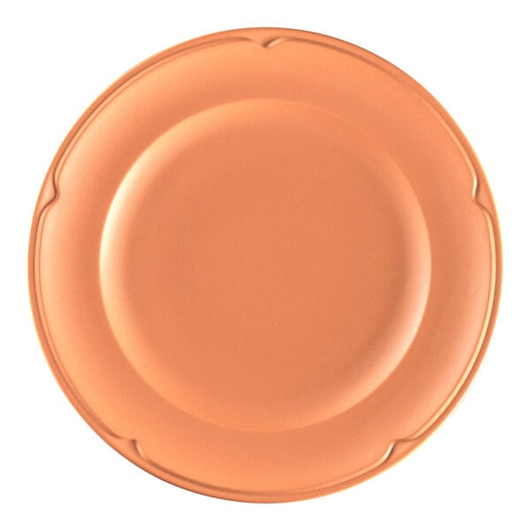 A close-up of a RAK Porcelain Terra Cotta flat plate with a bright orange color.