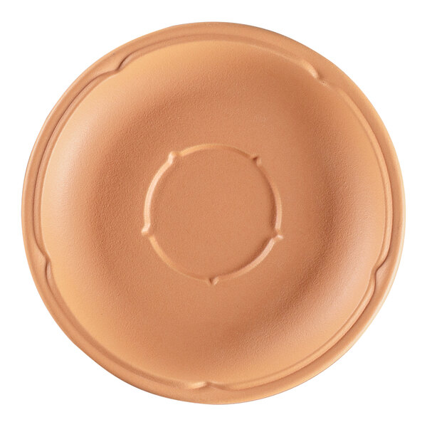 A close-up of a RAK Porcelain Terra Cotta saucer with a circular design.