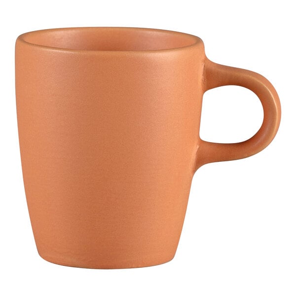 A close up of a RAK Porcelain Terra Cotta espresso cup with a handle.