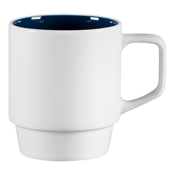 A white porcelain mug with a blue handle.