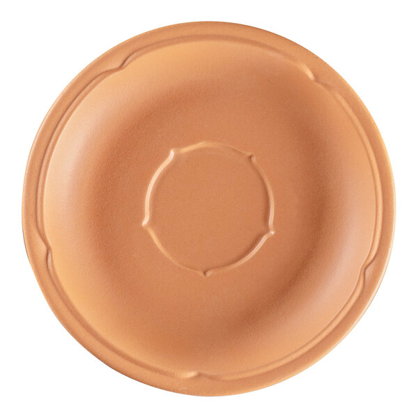 A close-up of a RAK Porcelain Terra Cotta saucer with a circular design on it.
