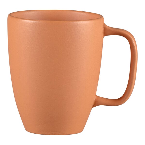 A close up of a RAK Porcelain Terra Cotta coffee mug with a handle.