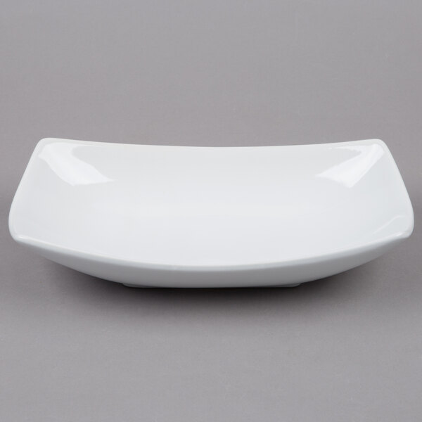 An American Metalcraft oval stoneware bowl in white on a gray background.
