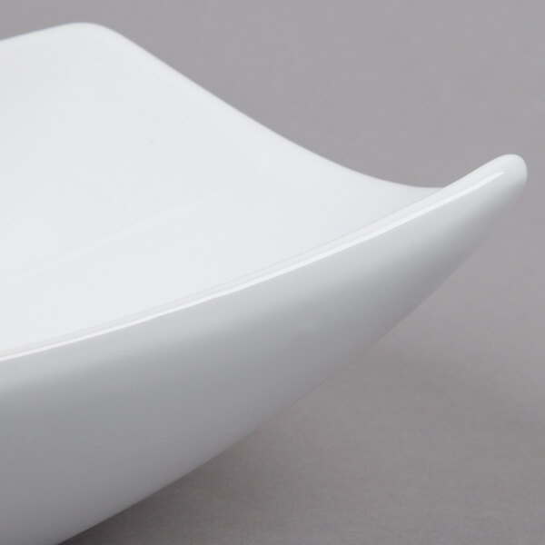 An American Metalcraft oval stoneware serving bowl with a curved edge.