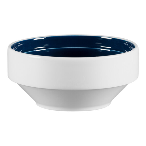 A white RAK Porcelain bowl with a blue rim.