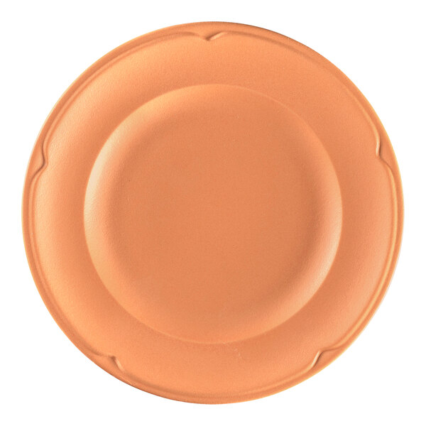 A close up of a RAK Porcelain Terra Cotta flat plate with a brown rim and orange design.