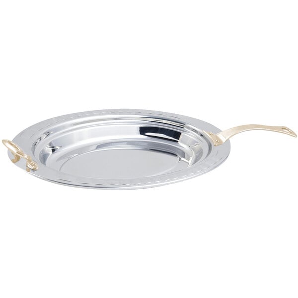 A silver stainless steel Bon Chef food pan with a long brass handle.