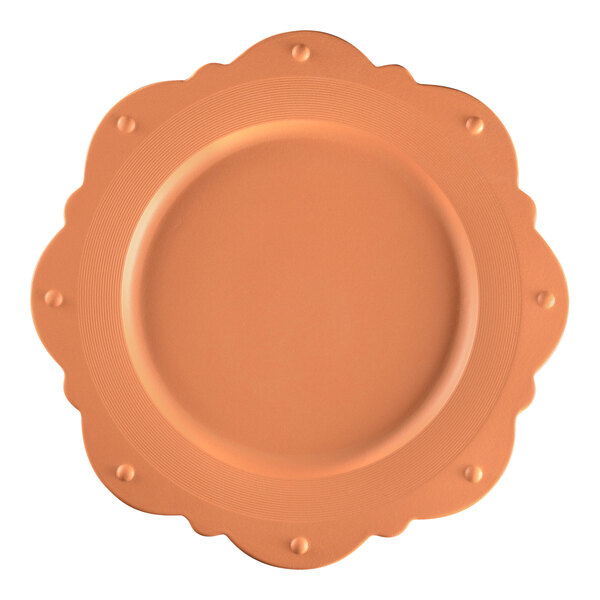 A RAK Porcelain Terra Cotta scallop plate with an orange rim.