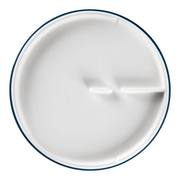 A close up of a RAK Porcelain white plate with blue trim.