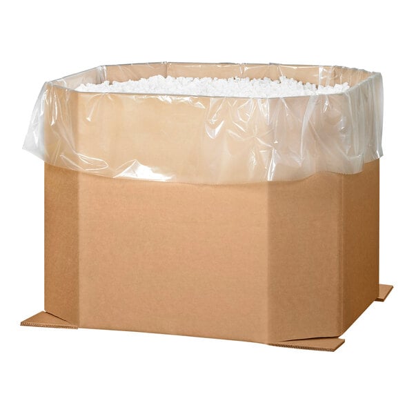 A Lavex kraft cardboard bulk bin filled with plastic bags.