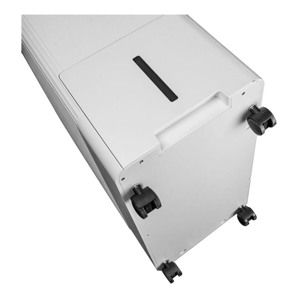 A white rectangular object with black wheels.