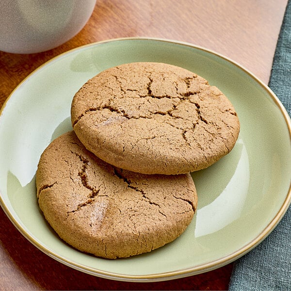 A plate of individually wrapped Red Plate Foods vegan ginger cookies on a table.