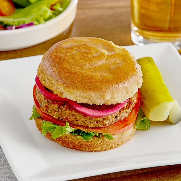 A Katz Gluten-Free burger on a plate with a pickle.