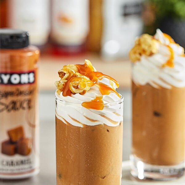 Two glasses of ice cream topped with Lyons Caramel Flavoring Sauce.