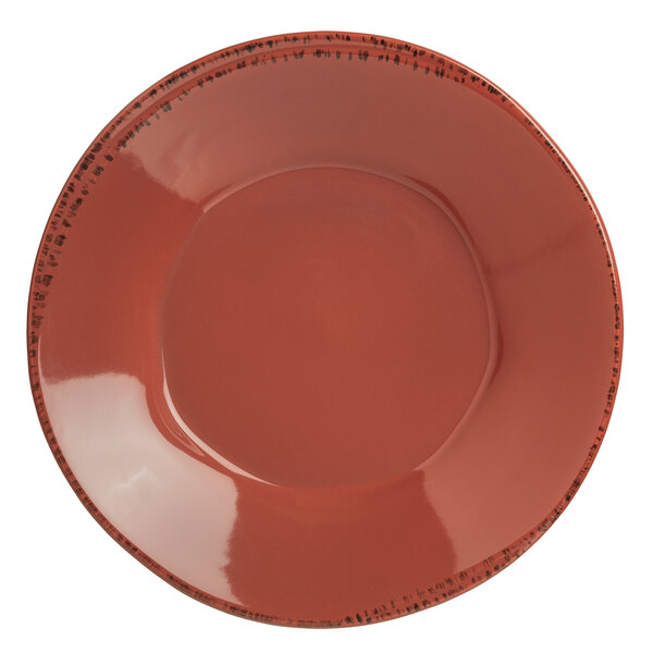 A close-up of a Libbey Farmhouse red porcelain bowl with a black rim.