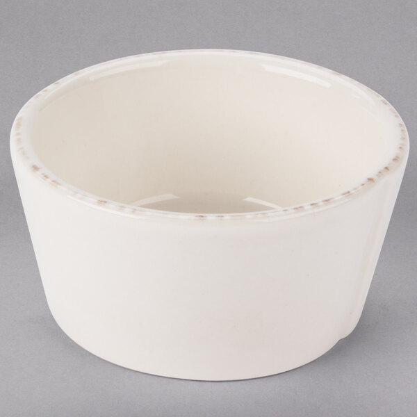 A white Libbey round porcelain sauce bowl.