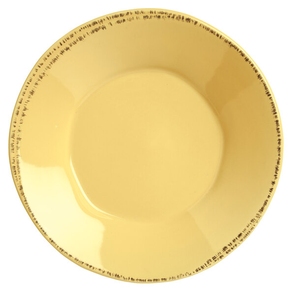 A Libbey round porcelain bowl in butter yellow with black lines on the rim.