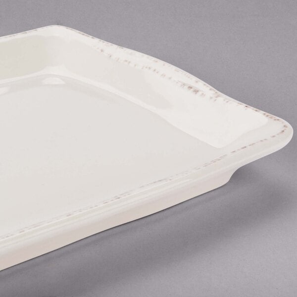 A white rectangular tray with a curved edge and a white rim.