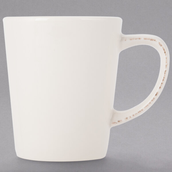 A white Libbey porcelain mug with a handle and rim.
