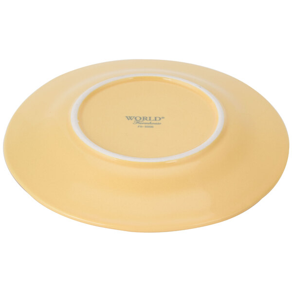 A Libbey Farmhouse yellow porcelain plate with a white wide rim.