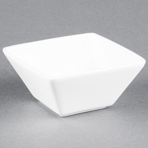 A Libbey Ultra Bright White square bowl on a gray surface.