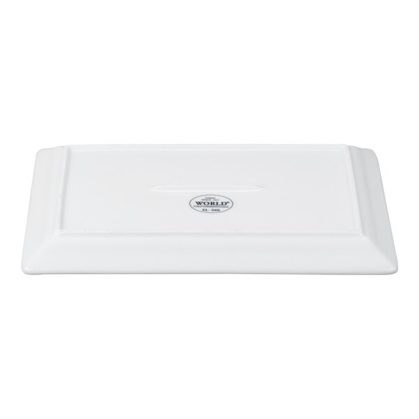 A rectangular white porcelain plate with a wide rim and an embossed design.