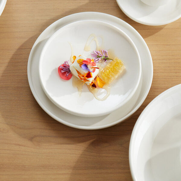A Libbey white porcelain plate with food on it.