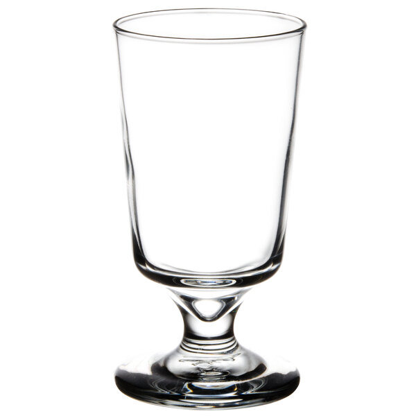 A Libbey footed highball glass with a small base.