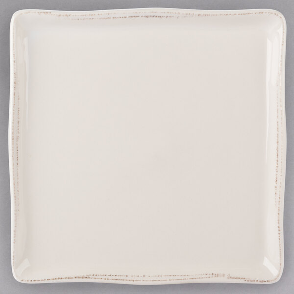 A white square Libbey porcelain tray with a small brown border.