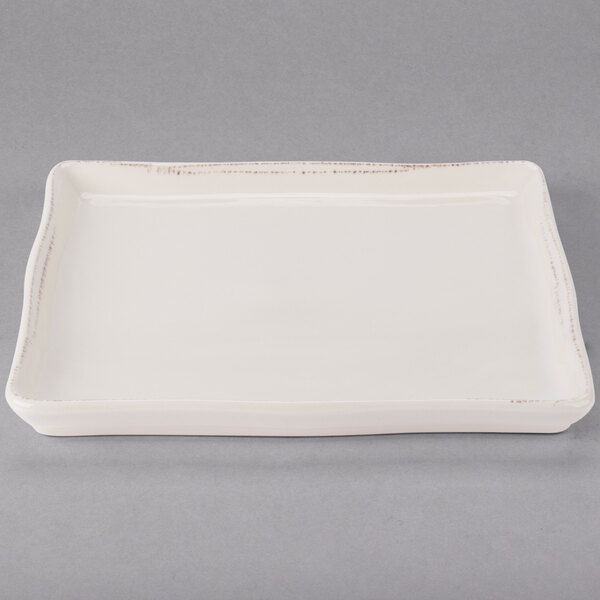 A white rectangular tray with a small handle.